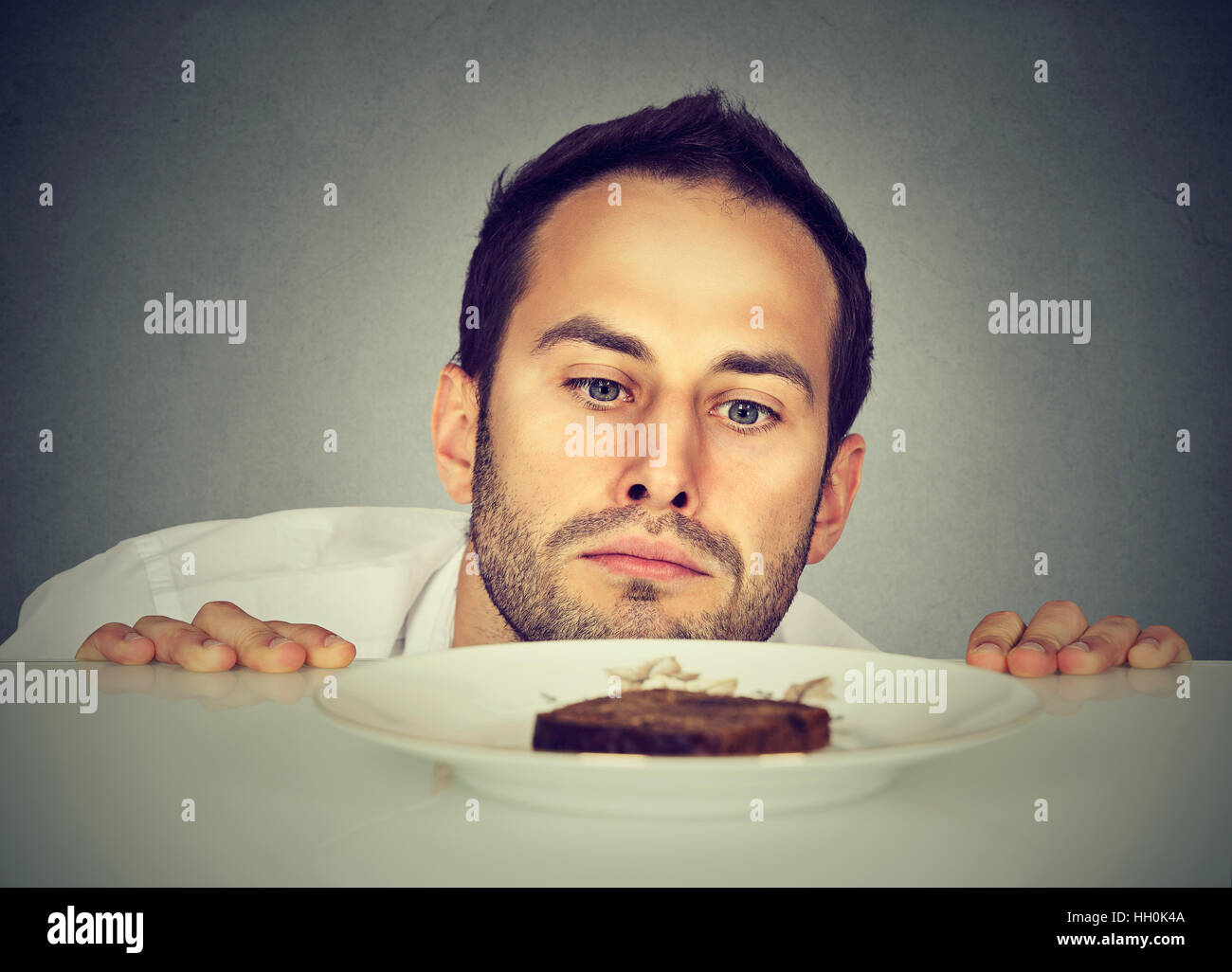 Hungry man craving sweet food Stock Photo