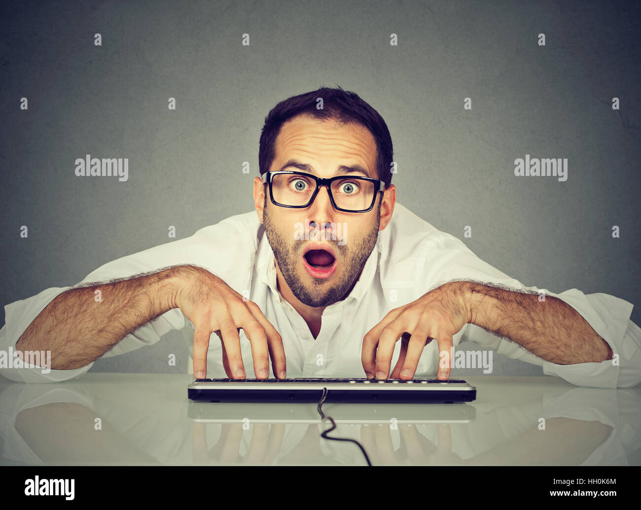 Computer geek typing on keyboard hires stock photography and images