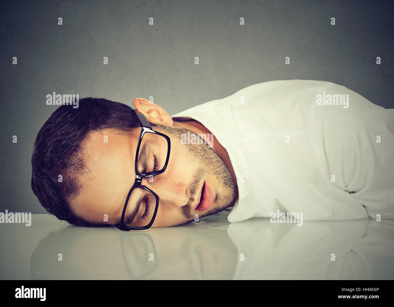 Man with glasses sleeping on a desk Stock Photo Alamy