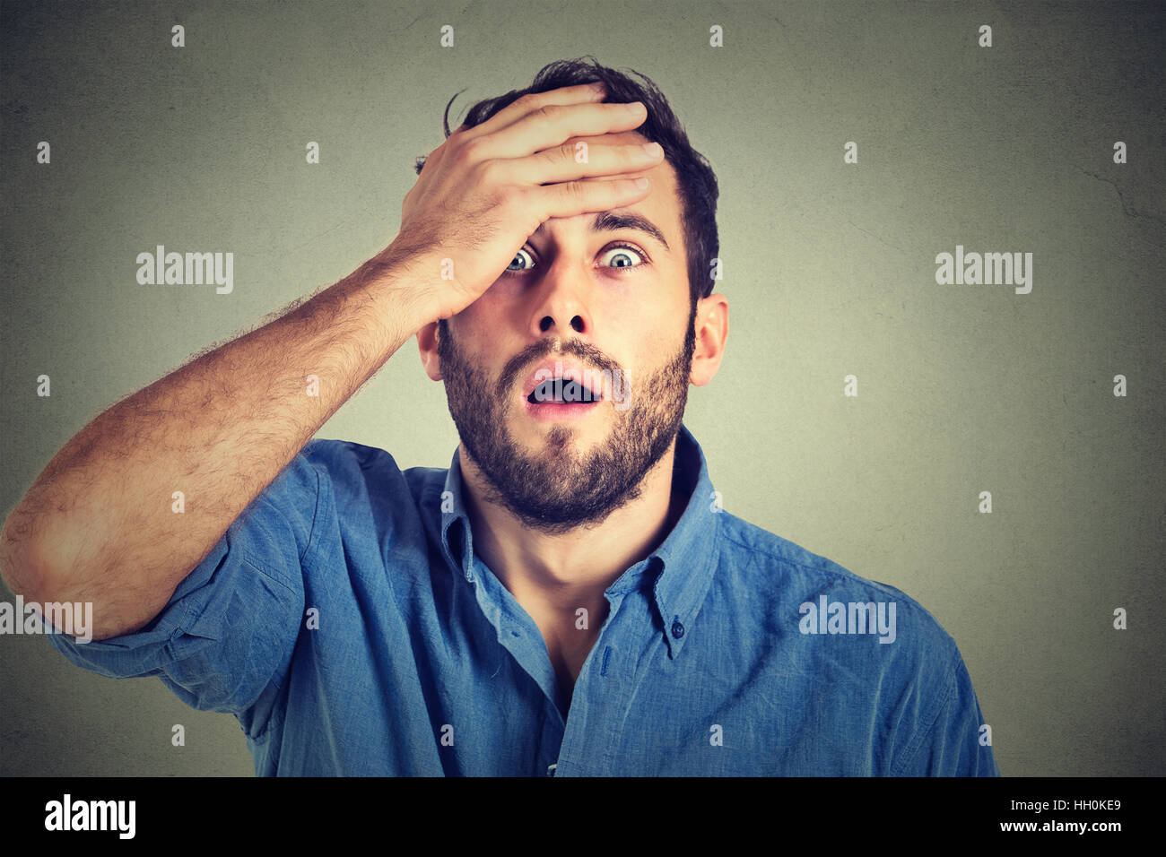 Portrait of young man with shocked facial expression Stock Photo