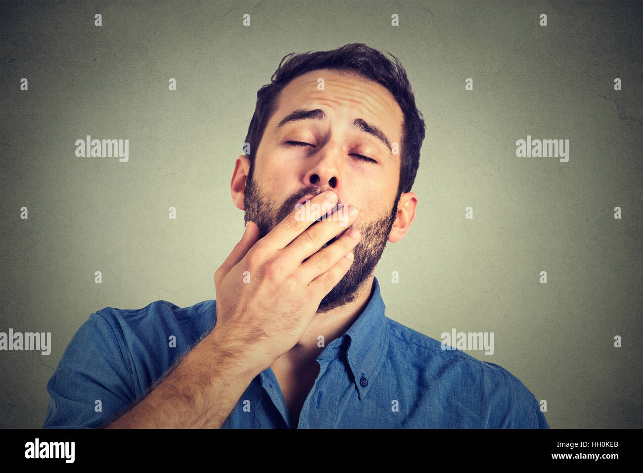 Man yawning isolated on gray background Stock Photo Alamy
