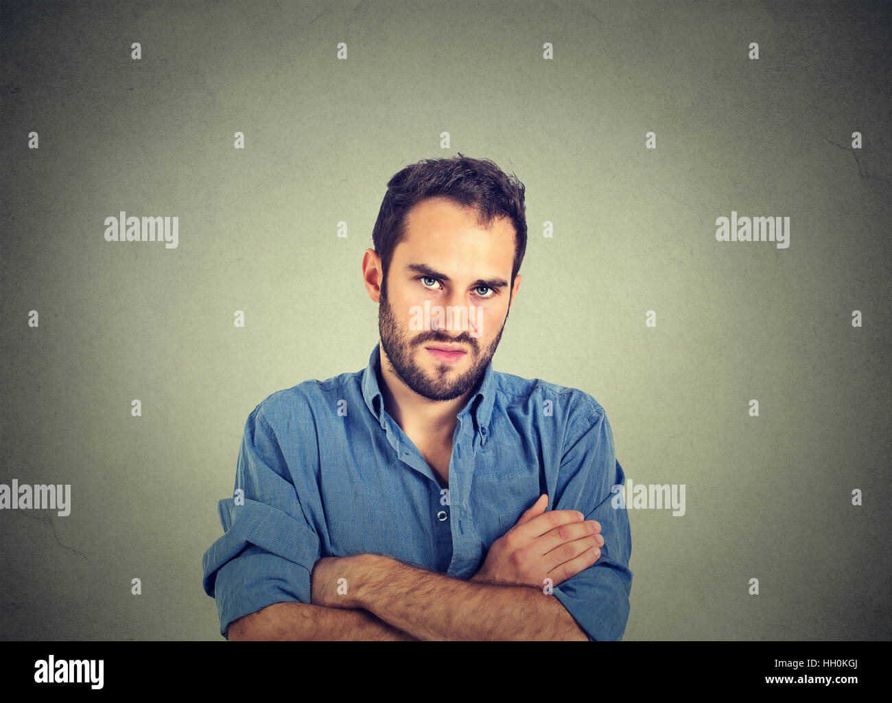 angry young man, about to have nervous breakdown, isolated on gray background. Negative human emotion facial expression feelings Stock Photo
