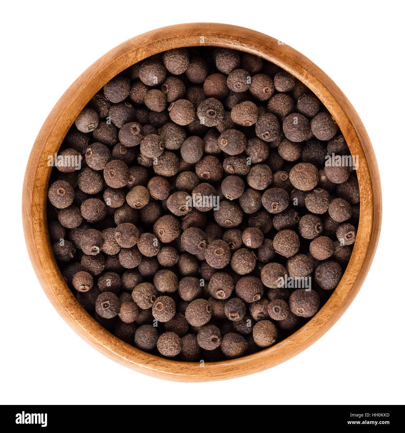 Allspice berries in wooden bowl. Dried unripe fruit, used as spice. Jamaica or myrtle pepper, Turkish yenibahar or newspice. Stock Photo