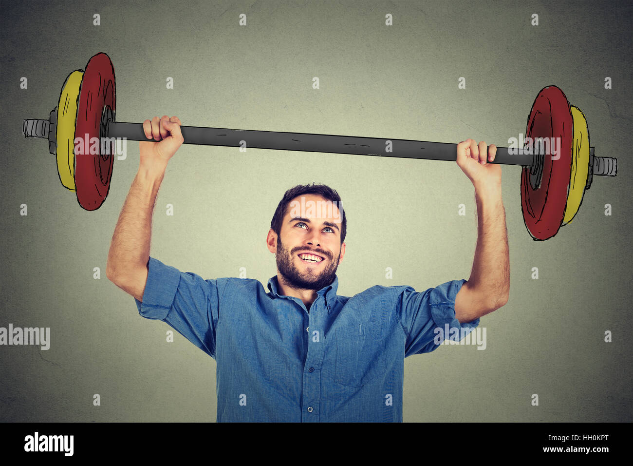 strong business man lifting barbell above head with two hands Stock Photo