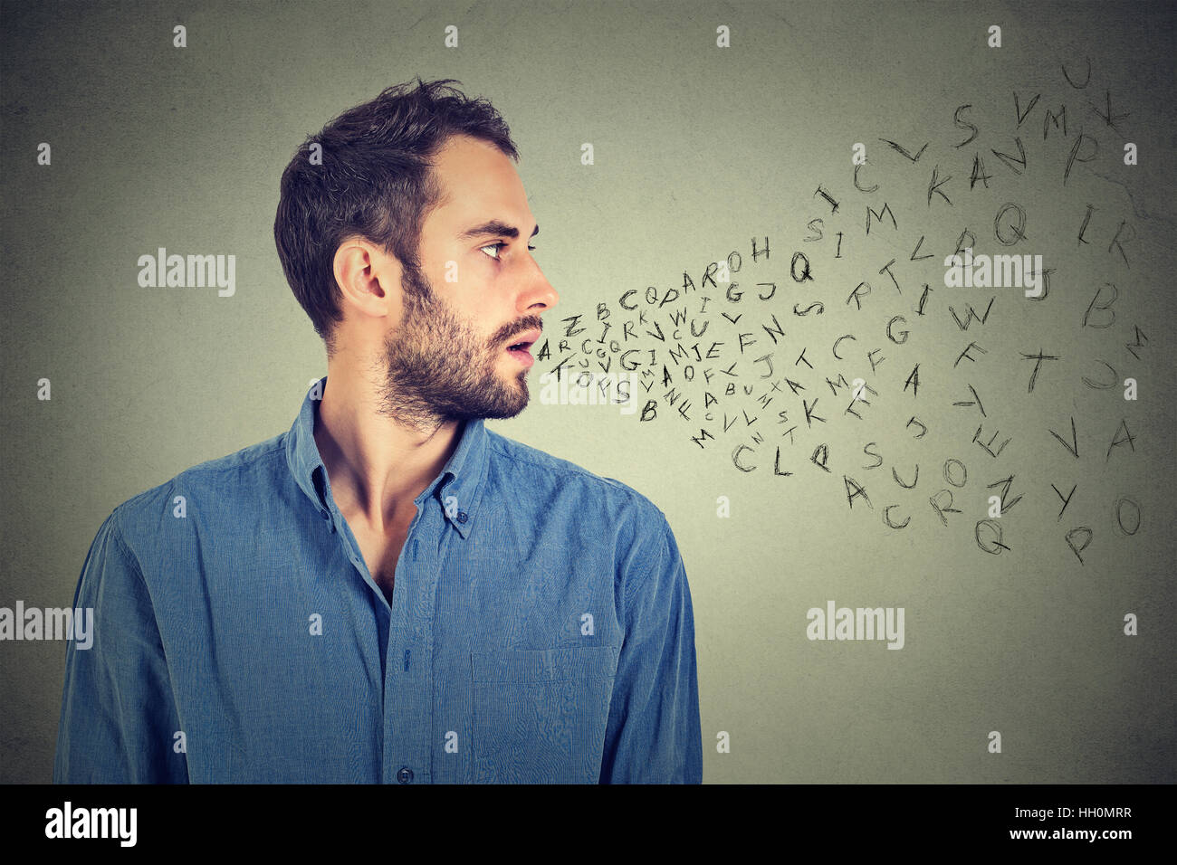 Man talking with alphabet letters coming out of his mouth. Communication, information, intelligence concept Stock Photo
