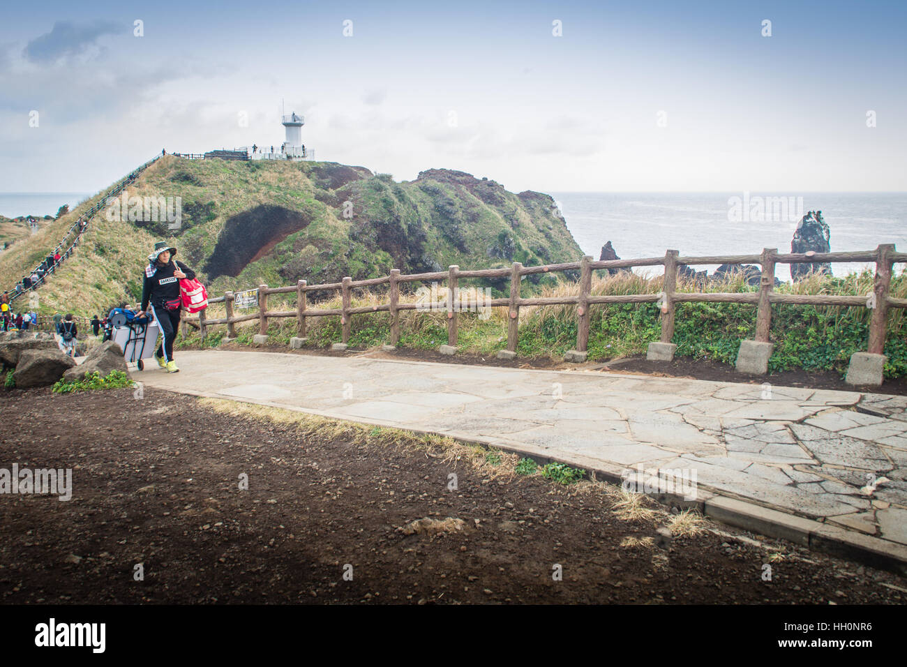 Jeju Island, Korea - November 13, 2016 : The tourist visited Lighthouse, the target of treking in Seopjikoji. Located at the end of the Eastern shore  Stock Photo