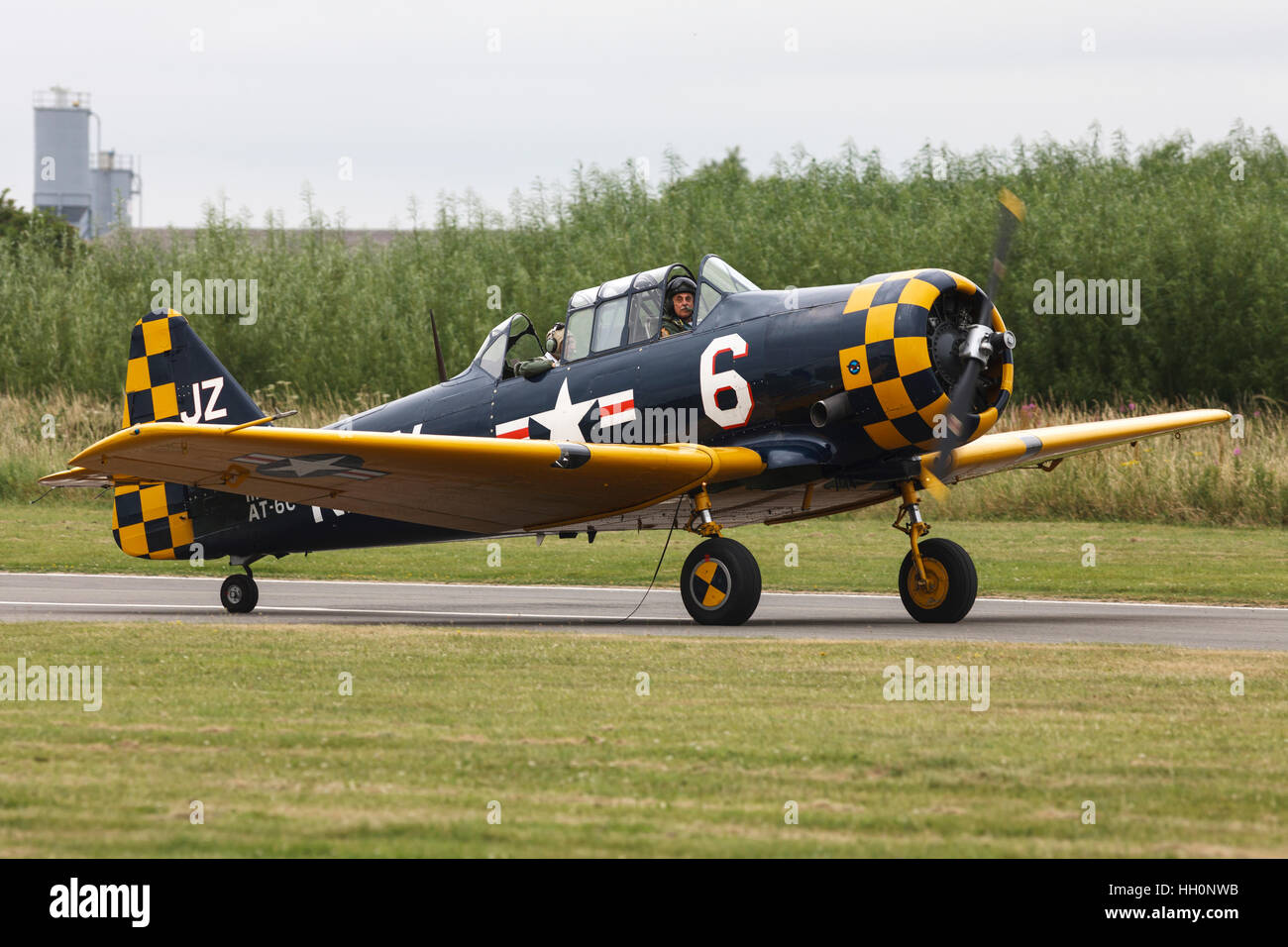 North American AT-6C Harvard IIA 111836 JZ-6 US Navy G-TSIX taxiing along runway at Sandtoft Airfield Stock Photo