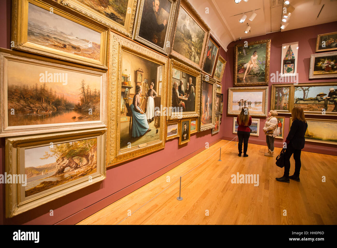 art gallery interior paintings female visitors Stock Photo