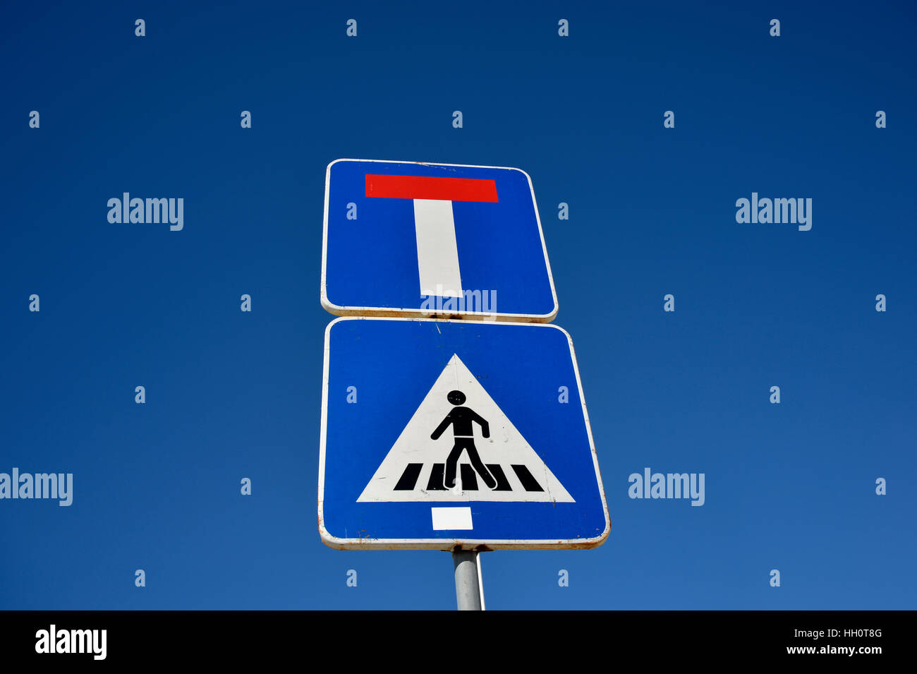 Pedestrian crossing and T junction road sign Stock Photo
