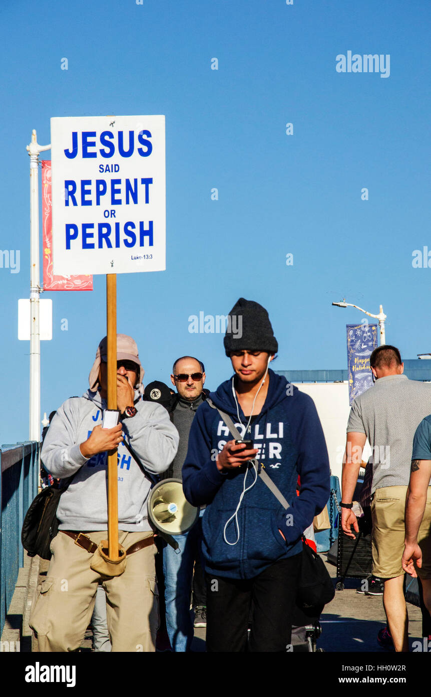 Preacher Reaching To Distracted Young Man. Stock Photo