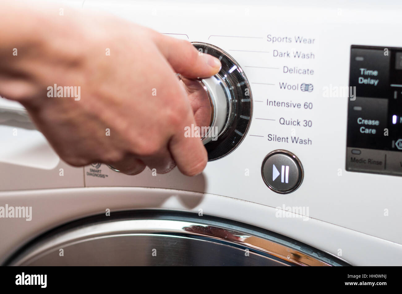 Laundry day - setting up washing machine program Stock Photo