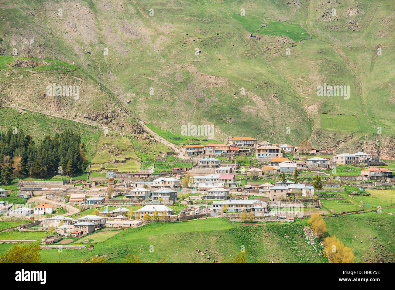 Tkarsheti Village On Mountain Background In Kazbegi District, Mtskheta-Mtianeti Region, Georgia. Spring Or Summer Season Stock Photo