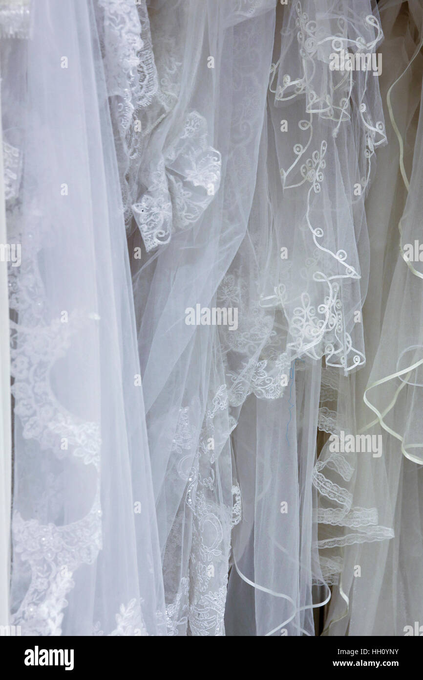 White wedding gowns in a charity shop Stock Photo