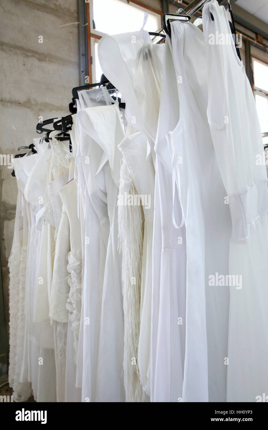 White wedding gowns in a charity shop Stock Photo