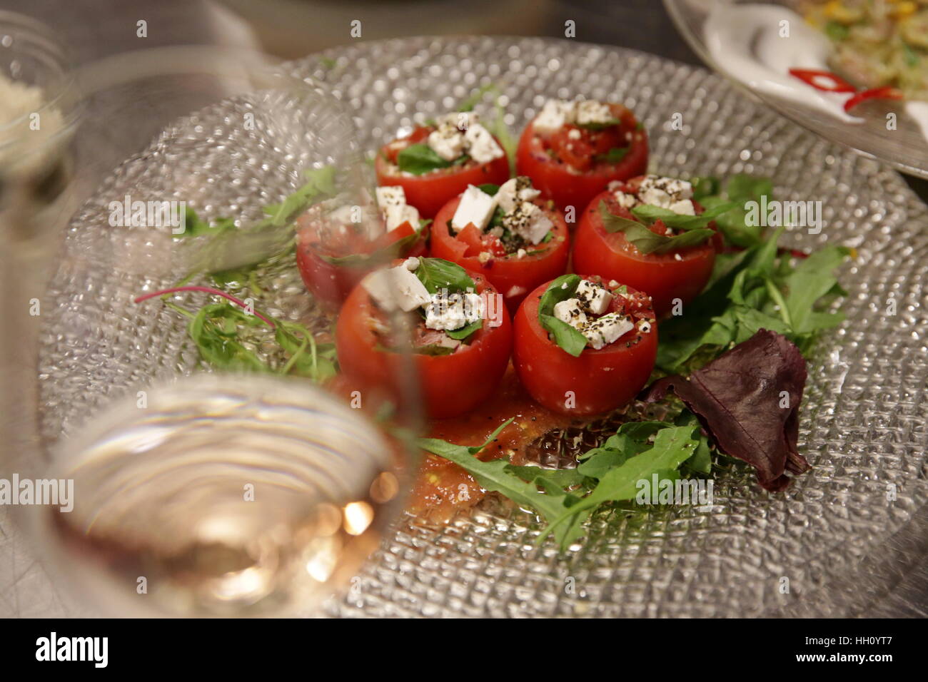 Stuffed tomatoes - tomatoes filled with cheese and basil Stock Photo