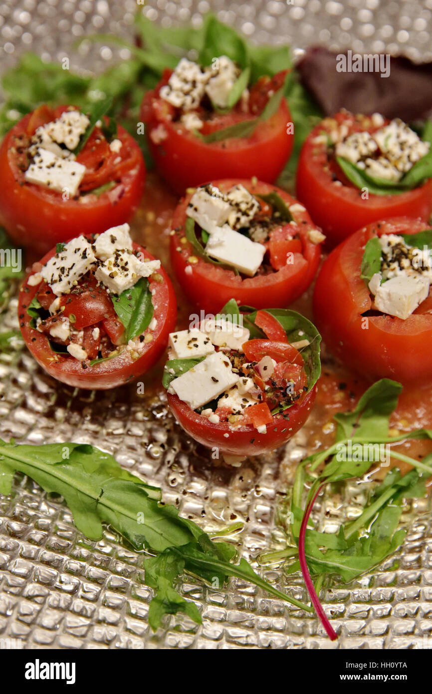 Stuffed tomatoes - tomatoes filled with cheese and basil Stock Photo