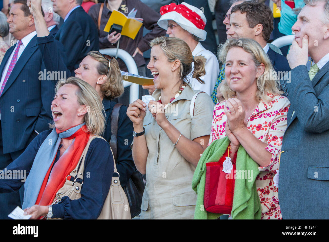Spectators at Goodwood cheering on a horse race Stock Photo