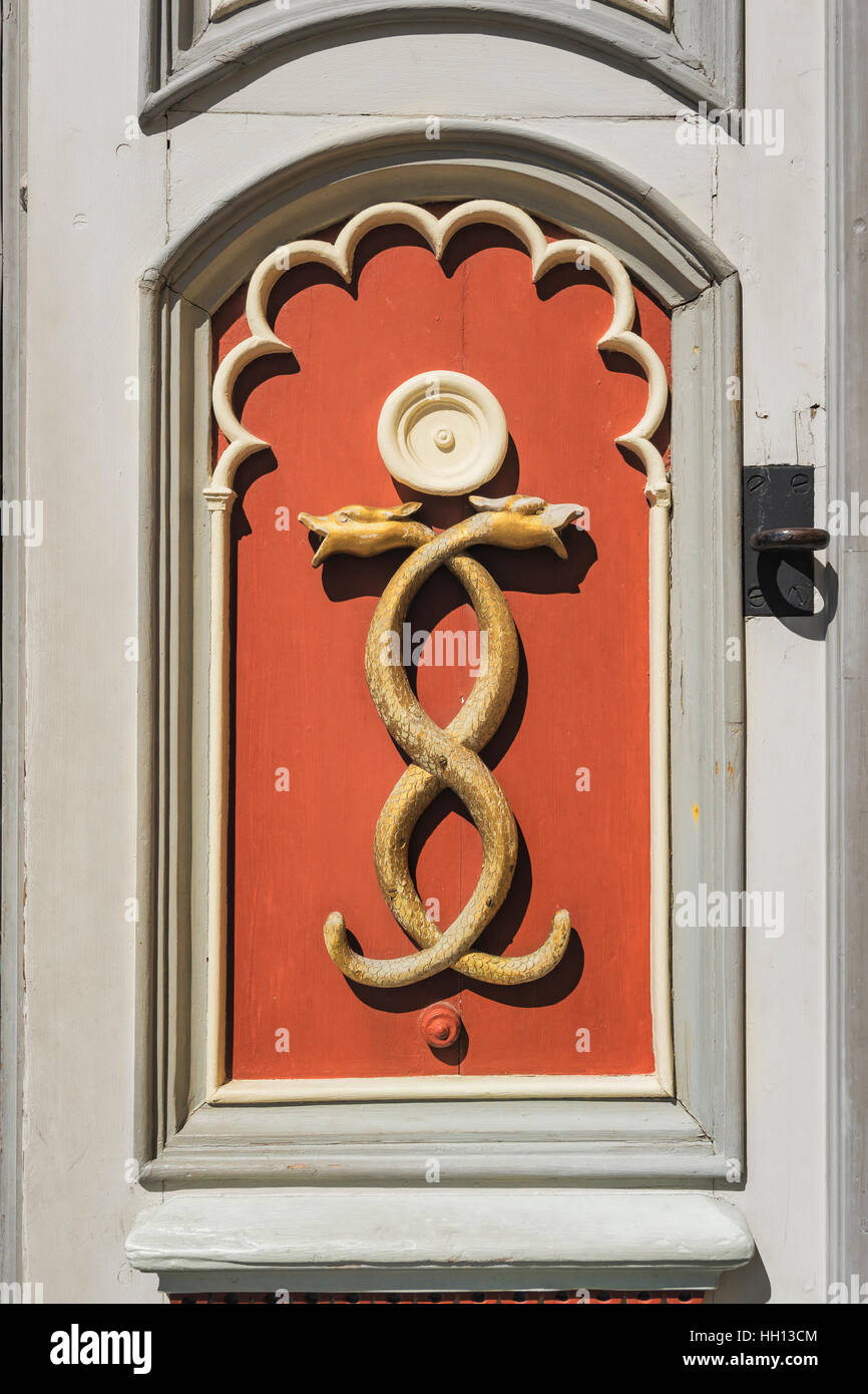 Detail view of a door with two crossing snakes. It is the door of the Tallinn Town Hall Pharmacy, Estonia, Baltic States, Europe Stock Photo