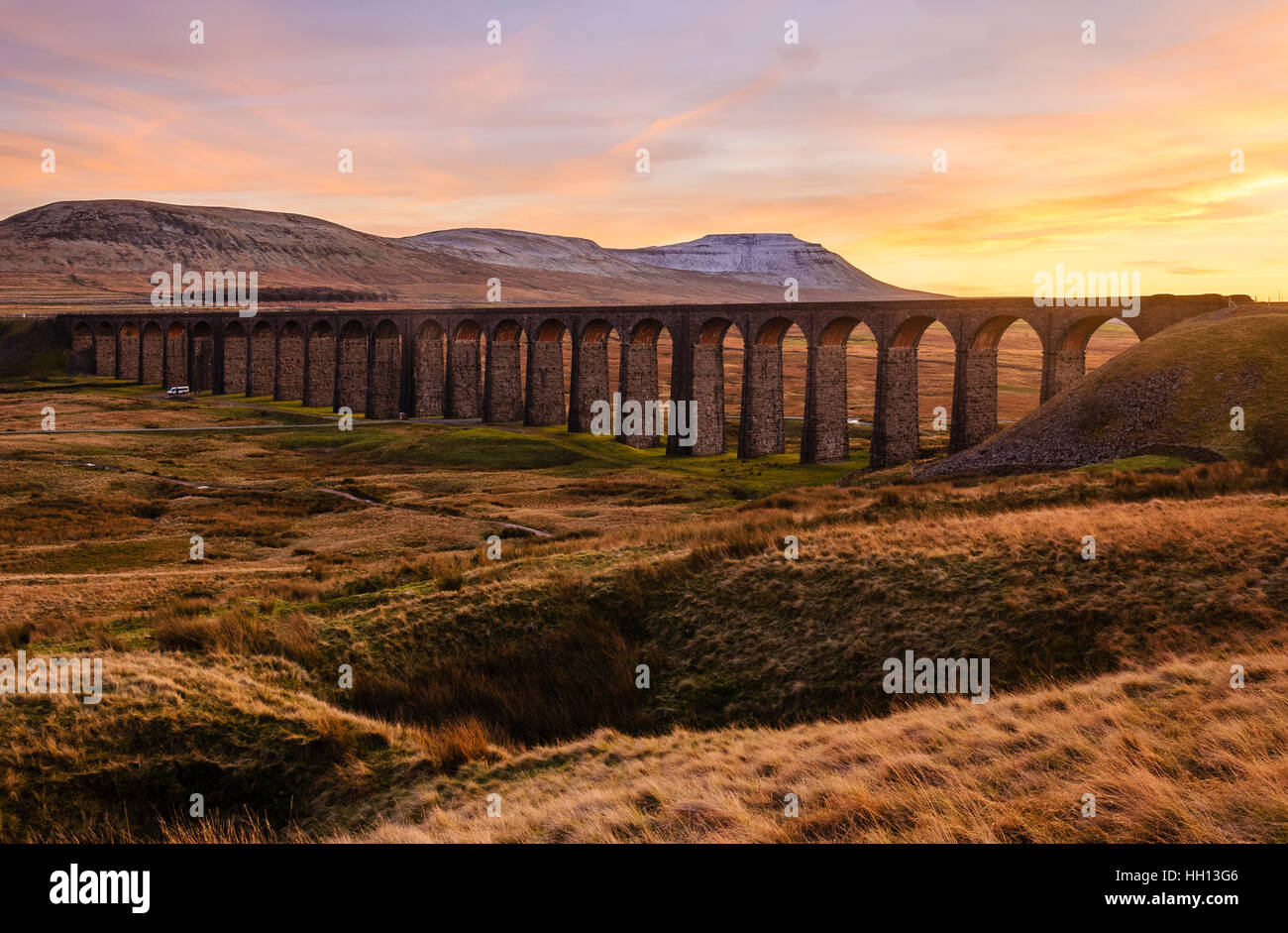 Sunset over the Ribblehead Viaduct on the Settle-Carlisle railway line with Ingleborough behind Stock Photo