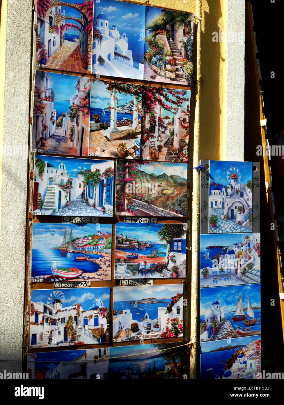 Watercolours on display outside a tourist shop in Mandraki, Nisyros, Greece. Stock Photo