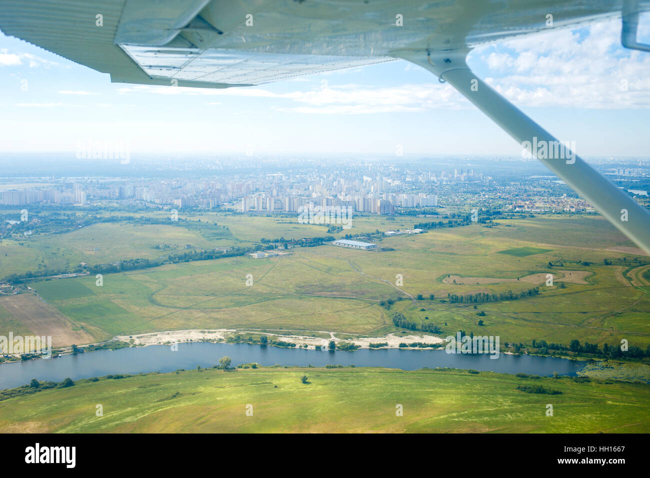 Aerial view from plane on river and city Stock Photo - Alamy