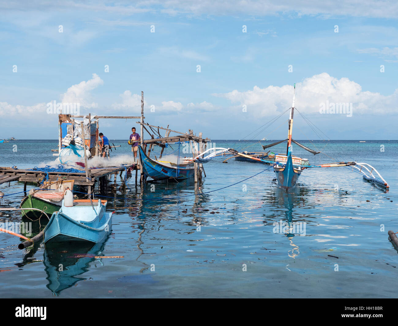 Fishing vessels and fishermen in Tinoto, a Muslim fishing village in Maasim, the province of Sarangani on Mindanao. Stock Photo