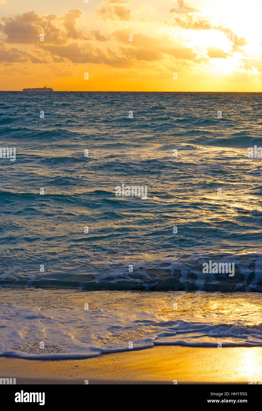 Golden sunrise over the stormy ocean Stock Photo - Alamy