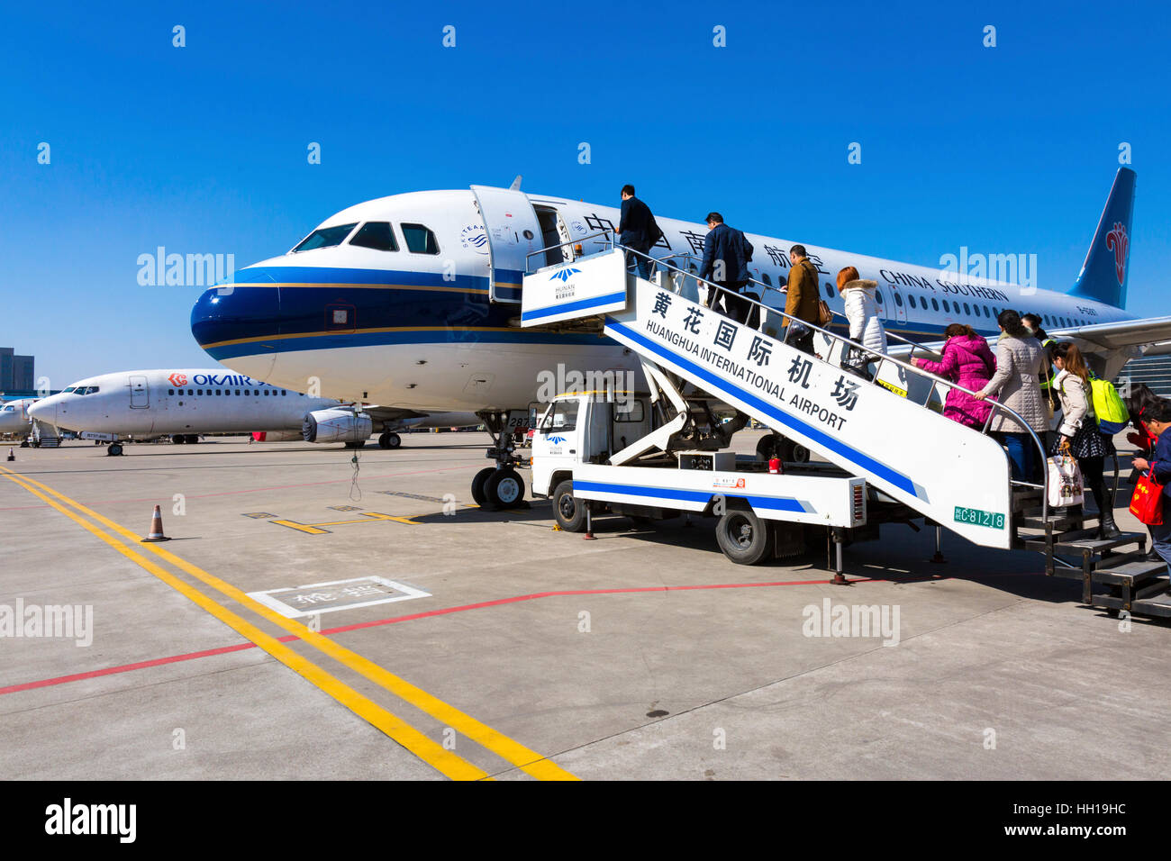Passengers boarding plane at Changsha Huanghua International Airport, Hunan province, China Stock Photo