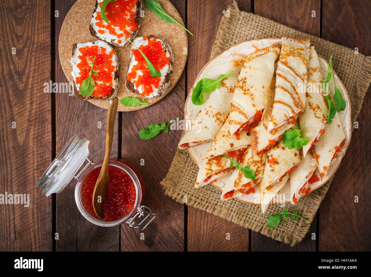 Pancakes with red caviar on plate. Russian cuisine. Maslenitsa Stock Photo