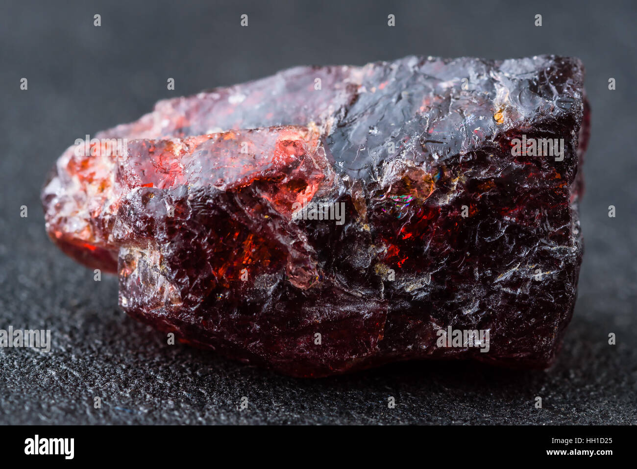 Uncut and rough deep red rhodolite garnet gemstone. Stock Photo