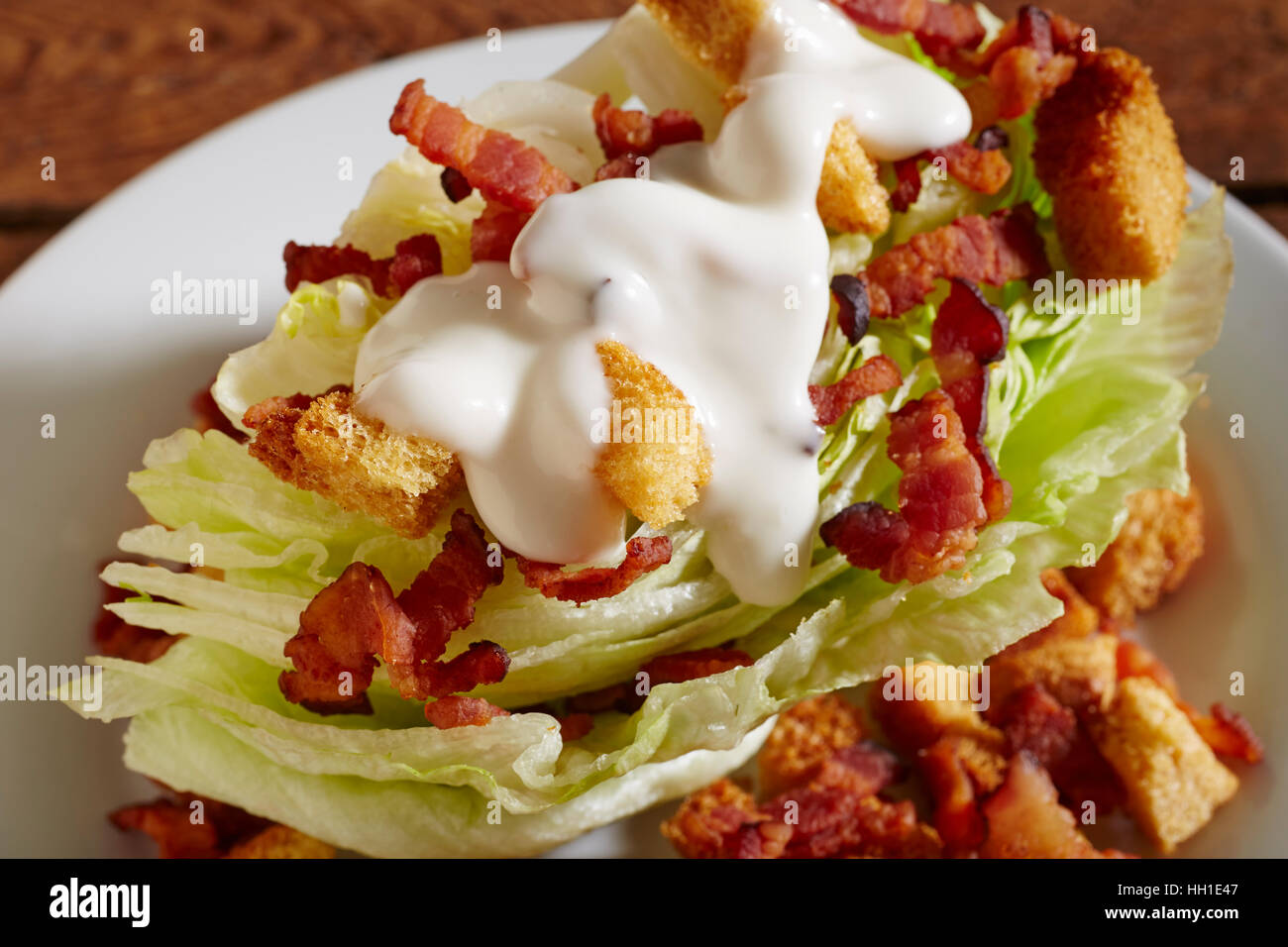 A classic wedge salad with ranch dressing. Stock Photo