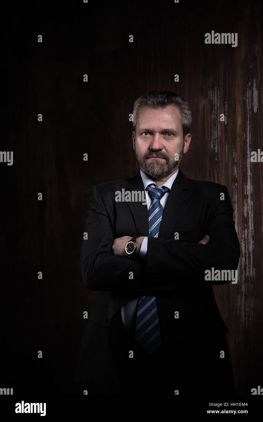 Portrait of a mature businessman on black background Stock Photo - Alamy