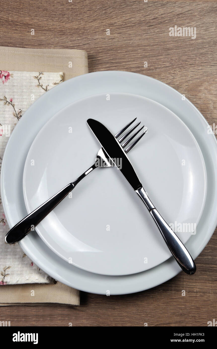 Dining etiquette - I still eat, do not like. Fork and knife signals with location of cutlery set Stock Photo