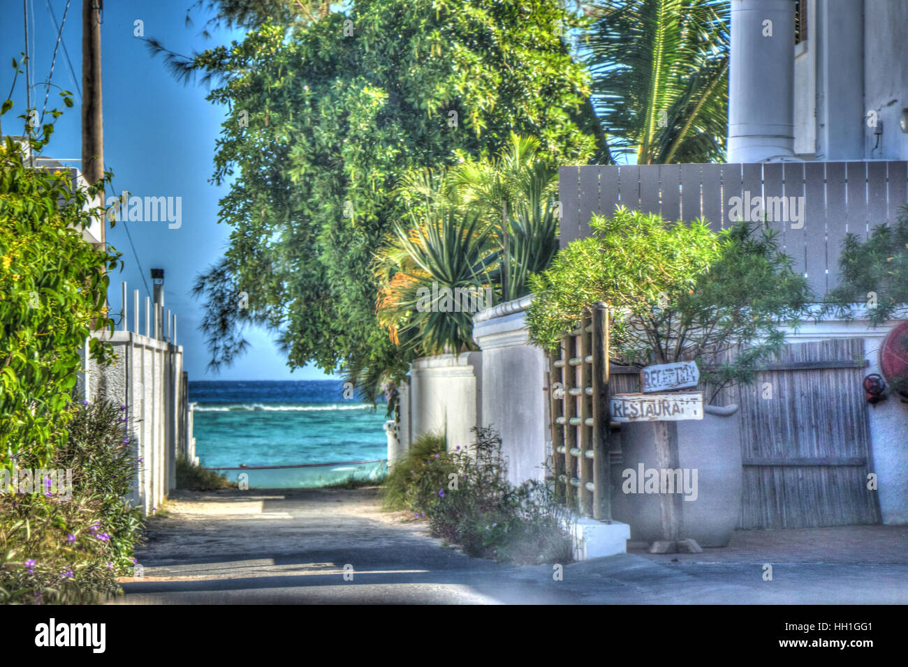 A quaint looking pathway to an inviting sea! This photo was taken outside the Bay restaurant in Mauritius. Stock Photo