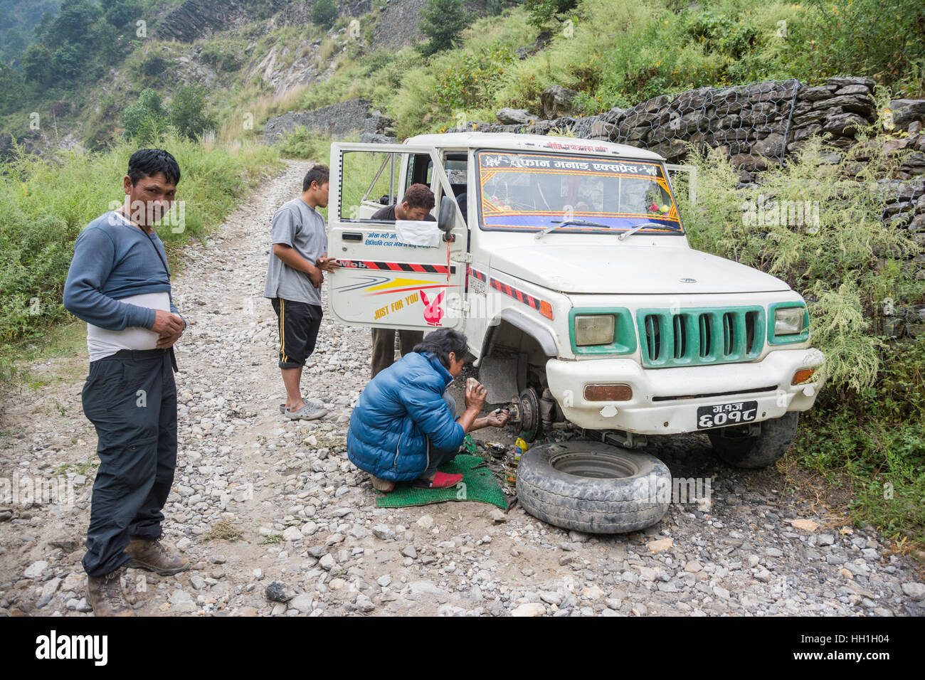 Nepali locals fixing a broken down jeep on the Annapurna trek, Nepal