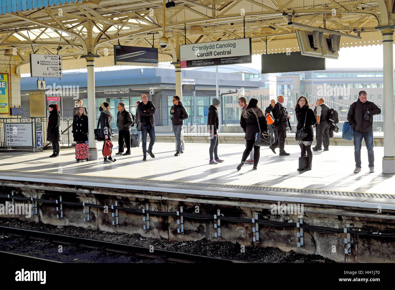 People standing on Cardiff Central Rallway Station platform in Wales UK  KATHY DEWITT Stock Photo