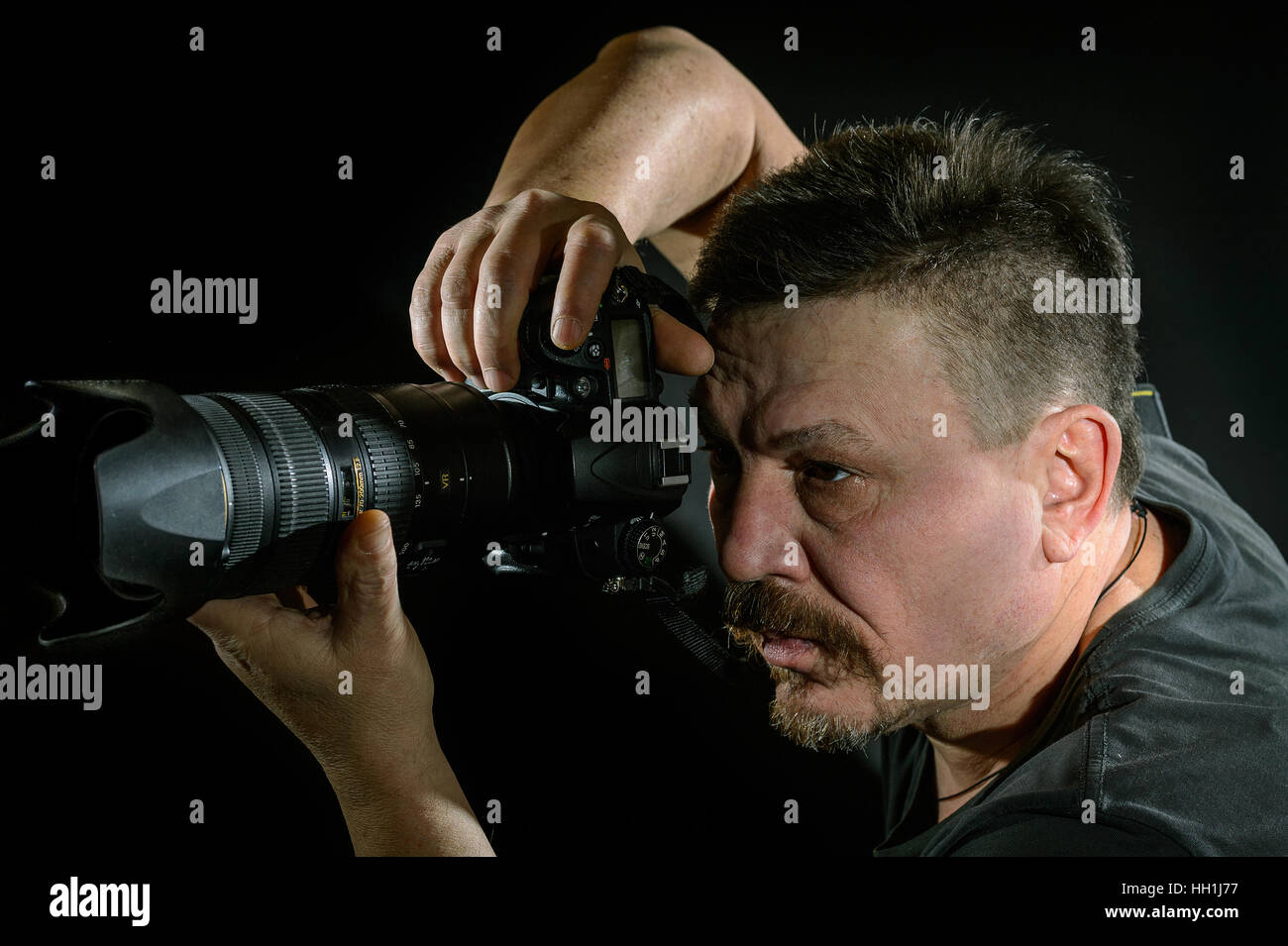 portrait photographer with a camera on black background Stock Photo Alamy