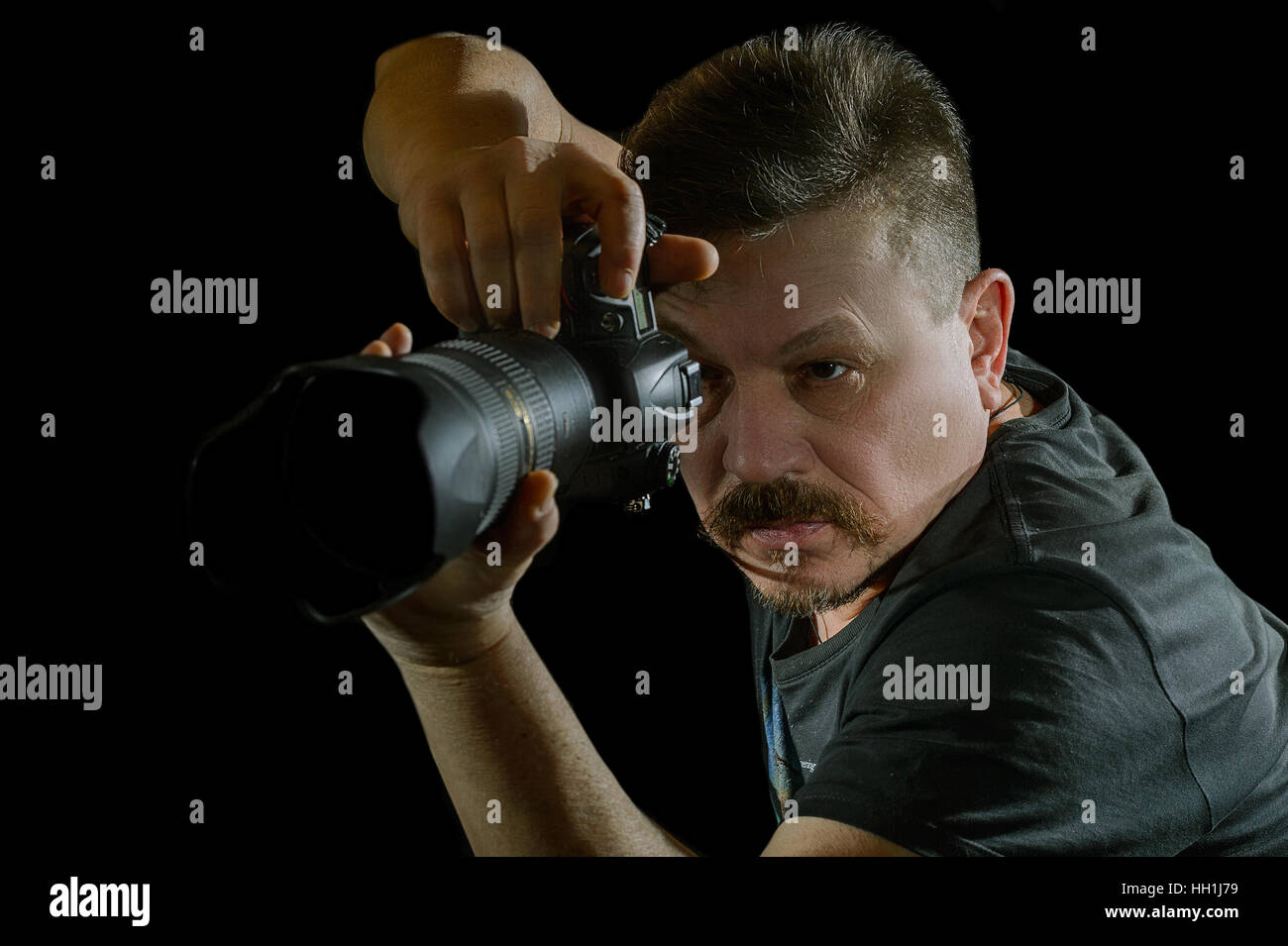 portrait photographer with a camera on black background Stock Photo Alamy