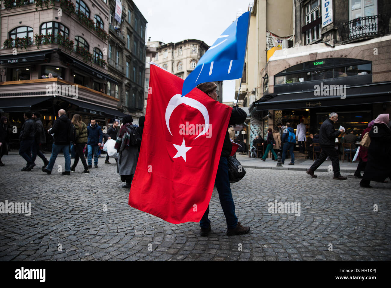 A man selling Ottoman Empire (blue) and Turkish (red) flags in Istanbul, Turkey. Stock Photo