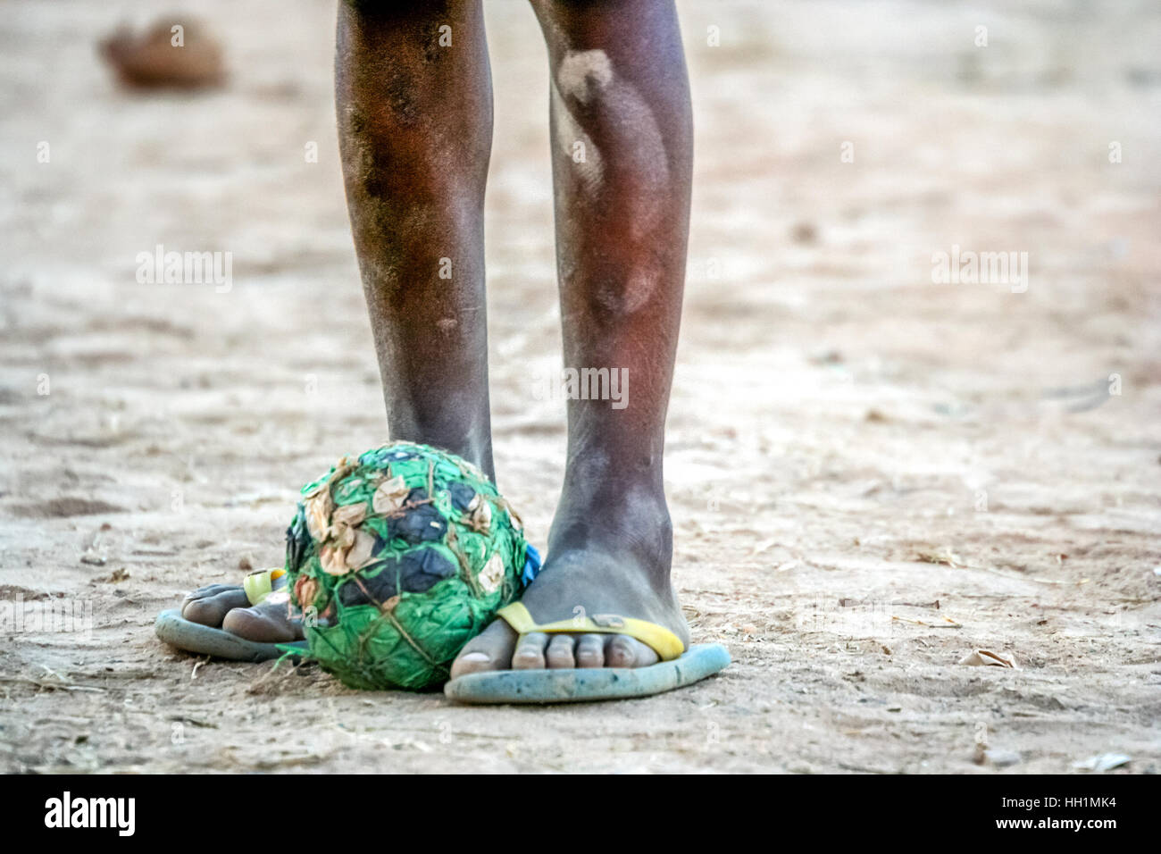 Home-made football ball at the feet of poor african boy Stock Photo