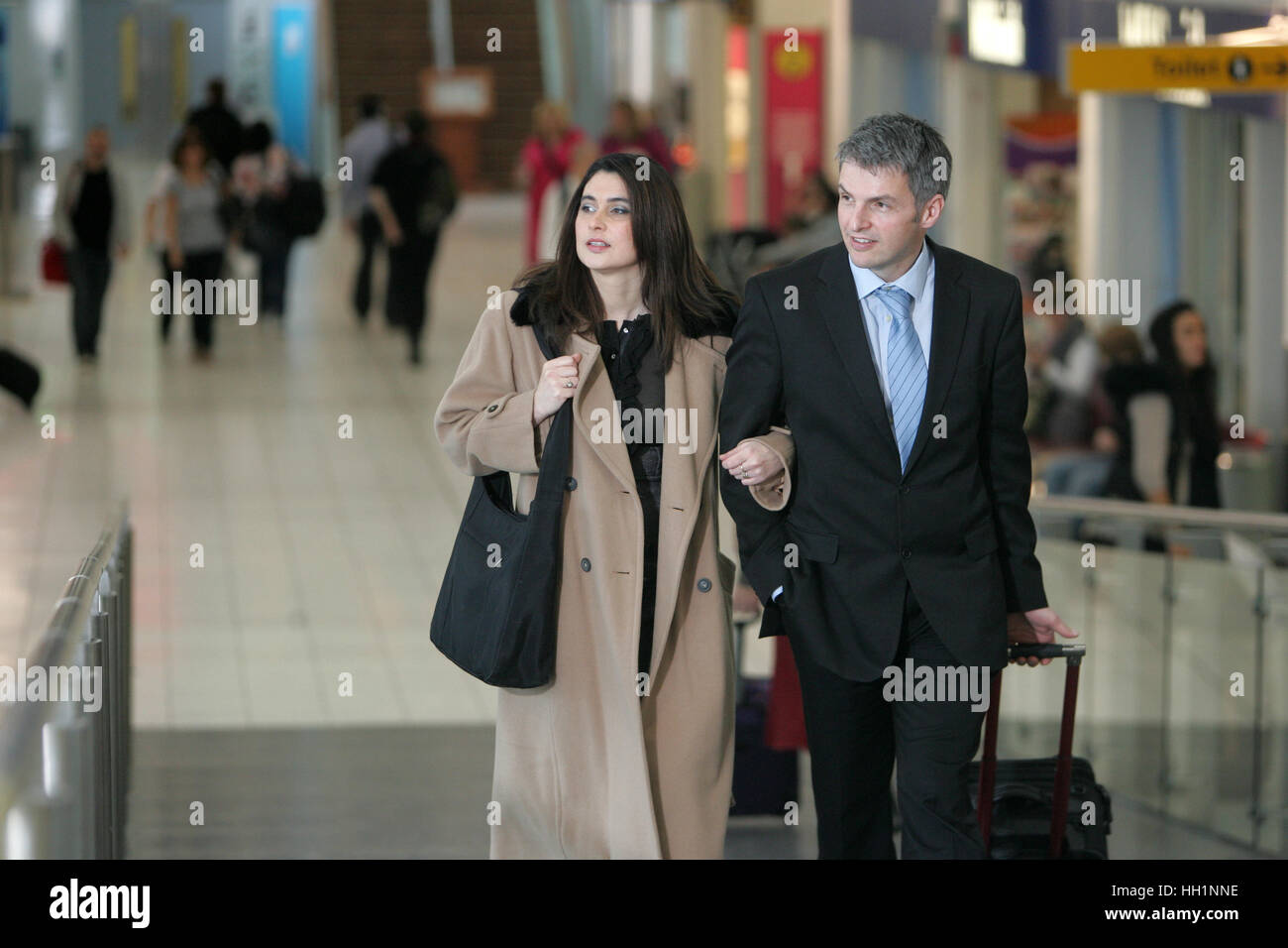 Couple getting ready to board flight in airport Stock Photo