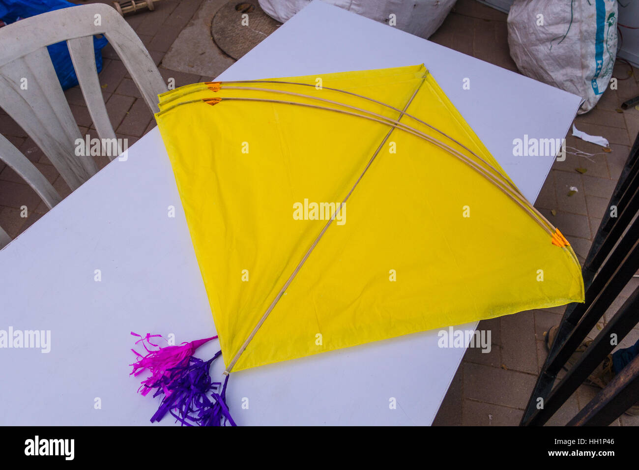 Yellow colored Indian Kites on a white background for sale in Hyderabad,India Stock Photo