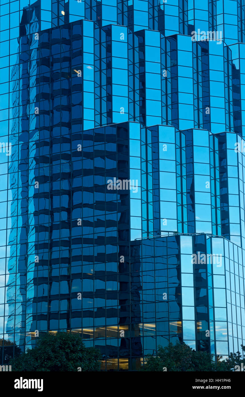 blue glass corporate office tower exterior at dusk and reflections in windows in bloomington minnesota Stock Photo