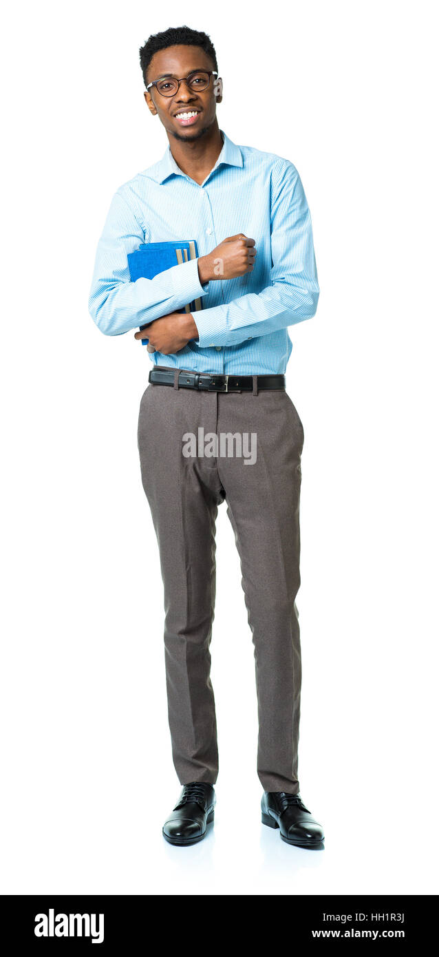 Happy african american college student standing with books in his hands on white background Stock Photo