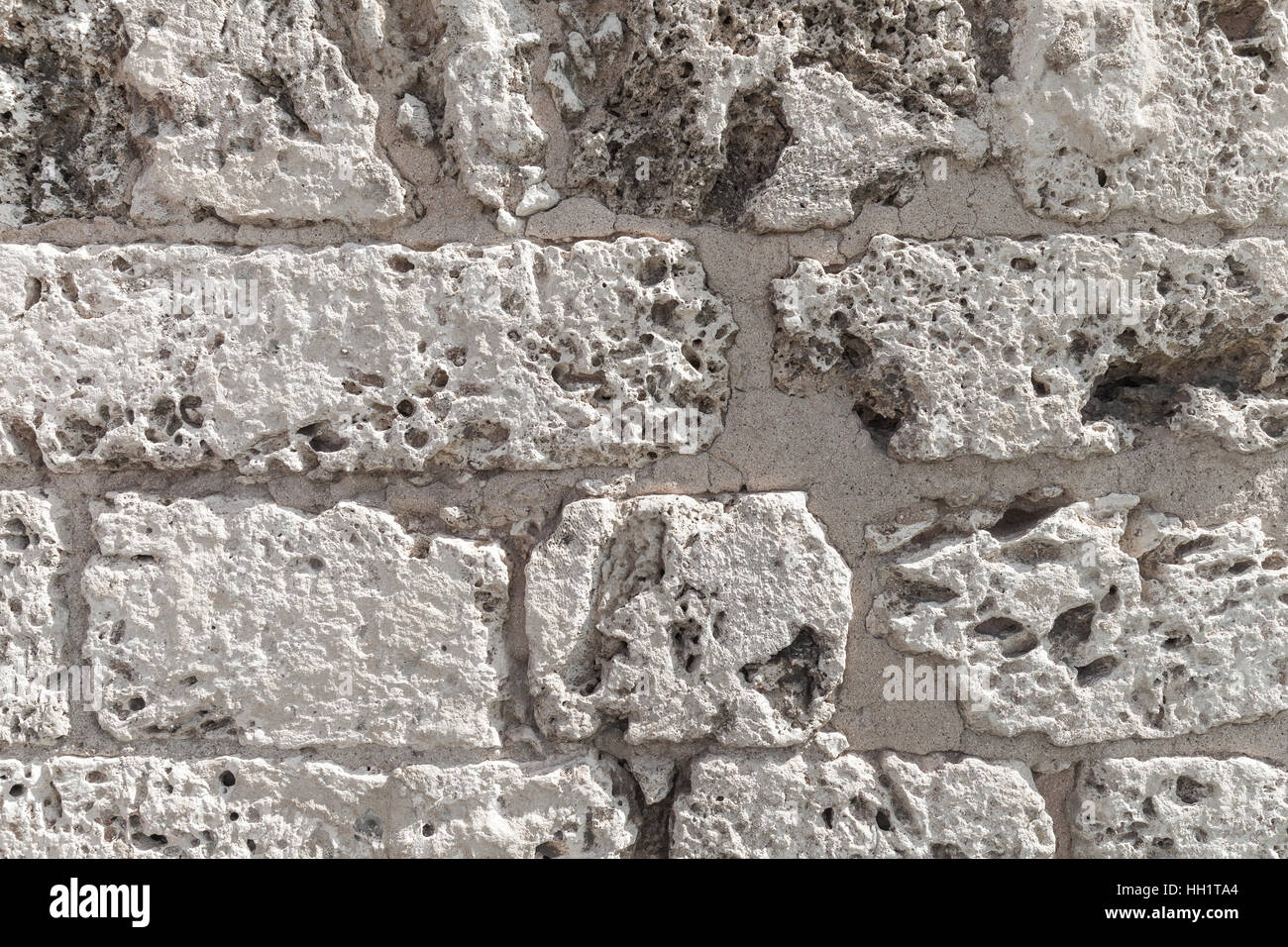 Old wall made of coquina stone, detailed background texture photo Stock Photo