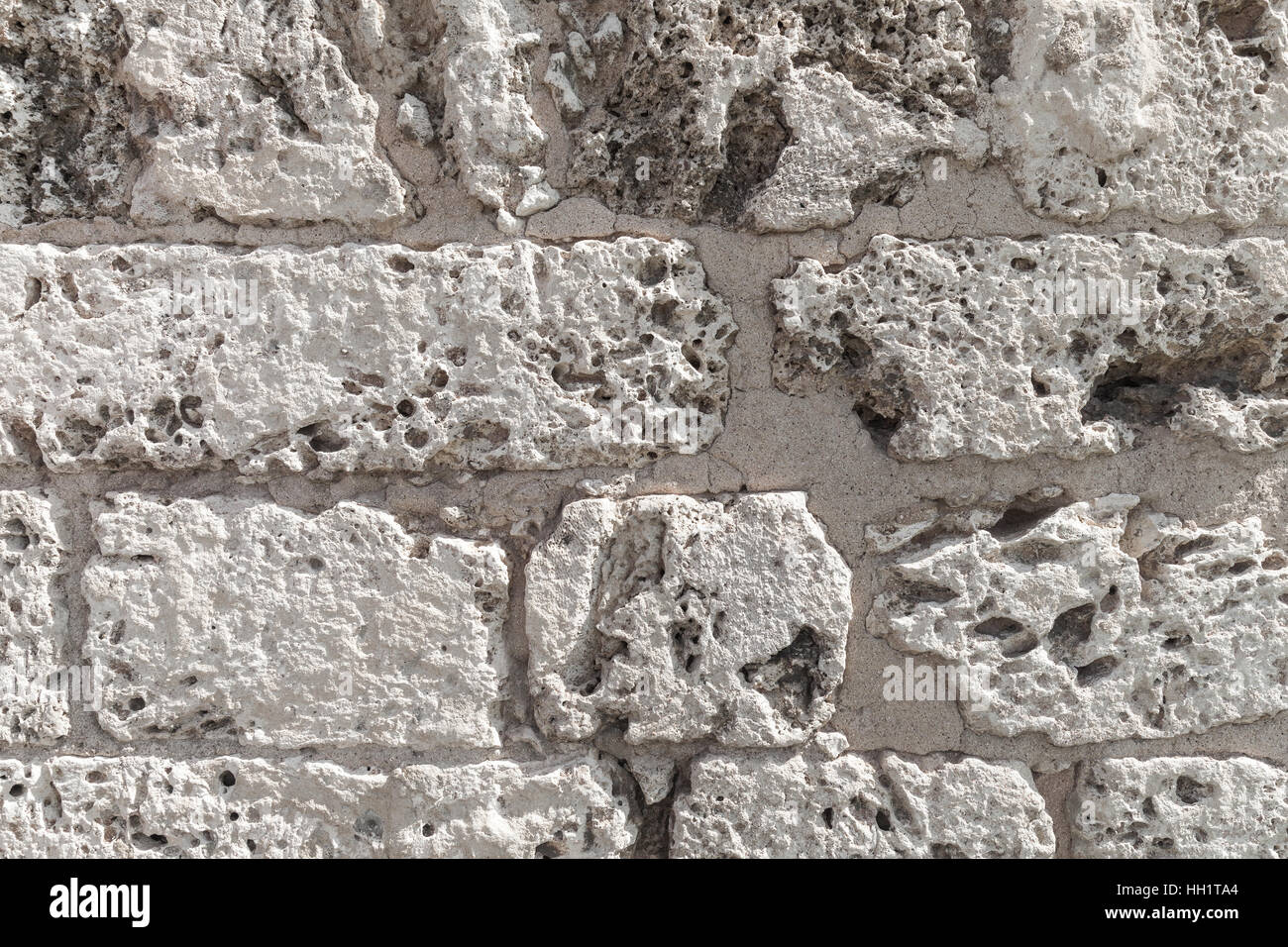 Old wall made of coquina stone, detailed background texture photo Stock
