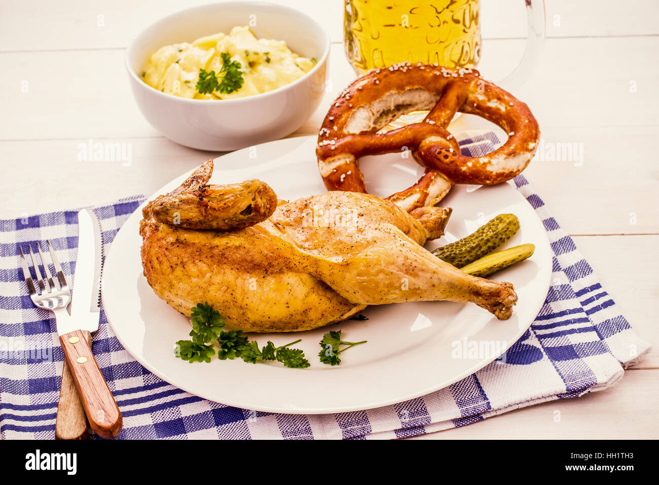 Half roast chicken, beer, pretzel and potato salad, Oktoberfest dinner