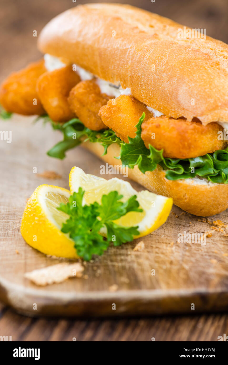 Sandwich with Fish Sticks (selective focus) on an old wooden table