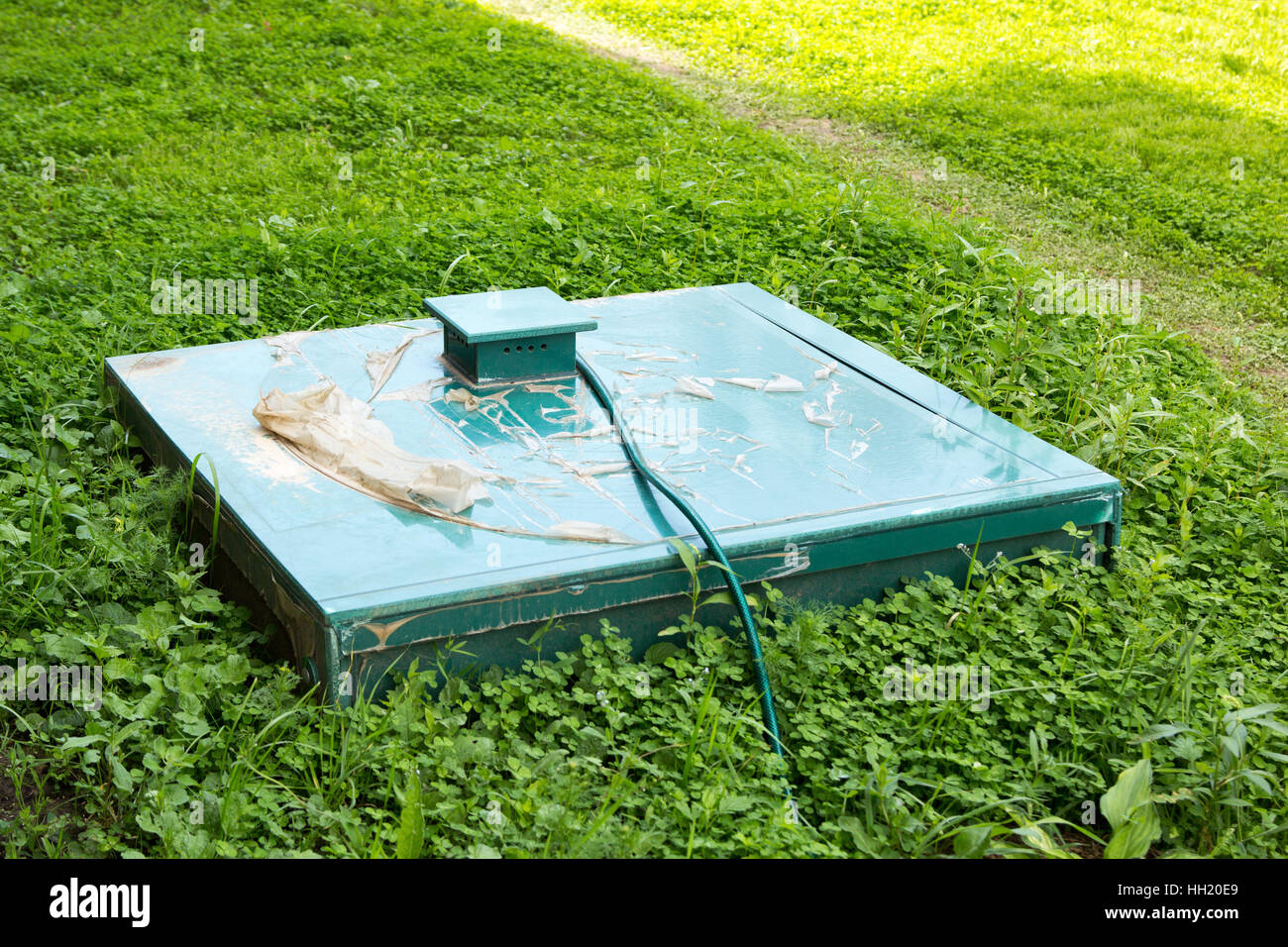 green cap of autonomous sewage in the grass Stock Photo