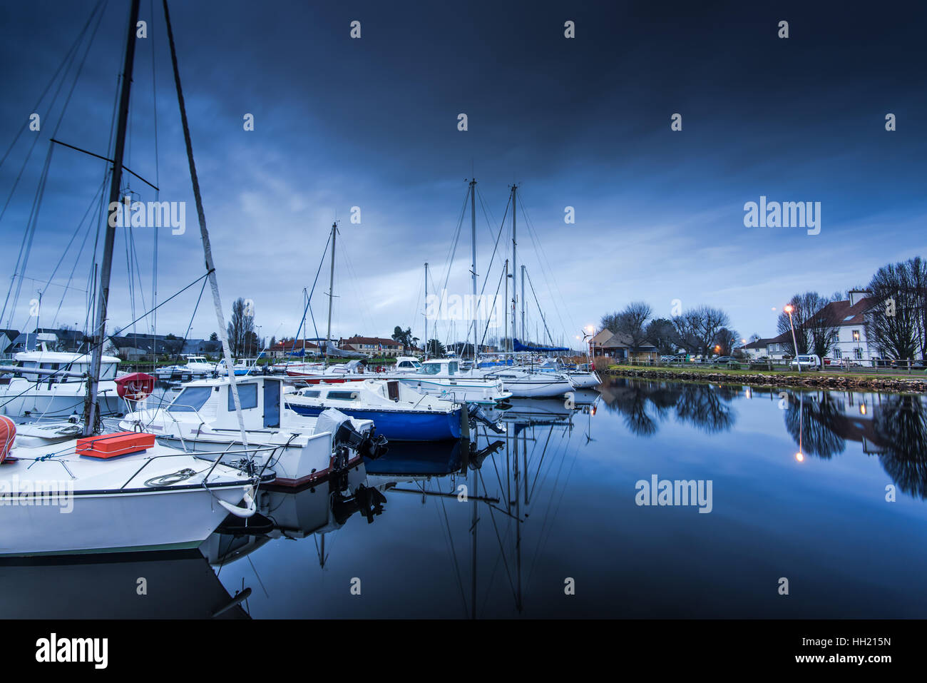 sailings boats in Carentan quay in Normandy,France at twilight Stock Photo